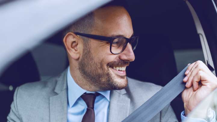 Man Putting Seatbelt On In Car